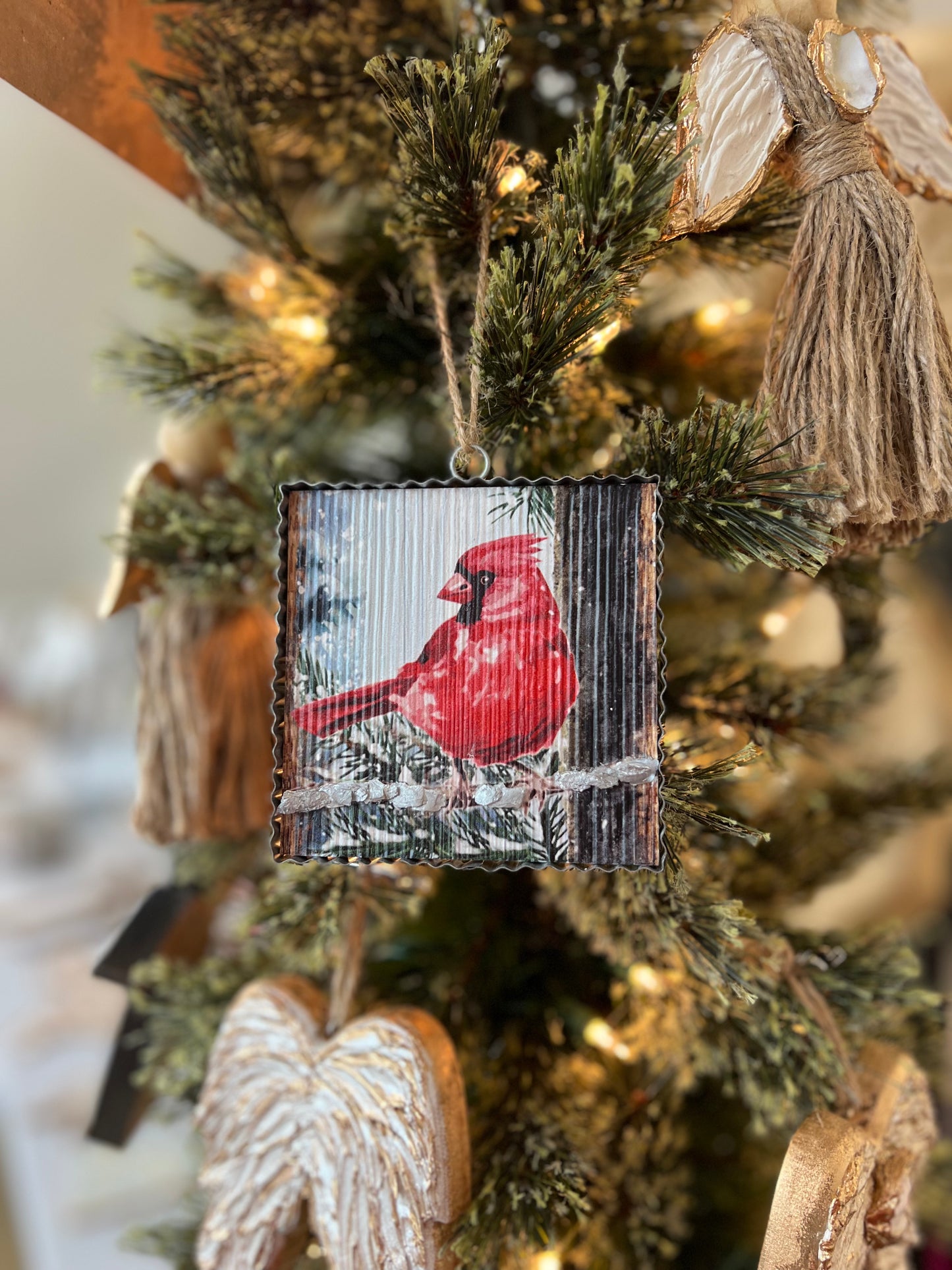 Tin framed, painted cardinal ornament with oyster shell accenting